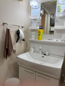 a bathroom with a sink and a mirror at kotobuki504condotel in Imai-kamichō +44 photos