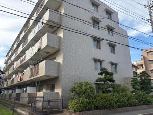 an apartment building with balconies on the side of it at kotobuki504condotel in Imai-kamichō
