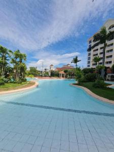 a large swimming pool in the middle of a resort at 2 Bedroom Mactan Beach Condo, La Mirada Residences in Lapu Lapu City