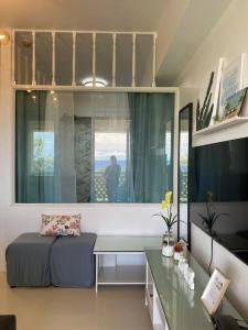 a room with a bed and a desk and a window at 2 Bedroom Mactan Beach Condo, La Mirada Residences in Lapu Lapu City +28 photos