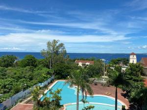 an image of a swimming pool at a resort at 2 Bedroom Mactan Beach Condo, La Mirada Residences in Lapu Lapu City