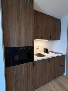 a kitchen with a sink and a microwave at Madrid Suites Moncloa-Aravaca, SOLO CHECK IN ON LINE - PARKING GRATUITO in Madrid