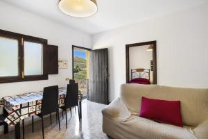 a living room with a couch and a table at Villa Palomino - Sleeps 6 - Parking - Pet Friendly in Gáldar