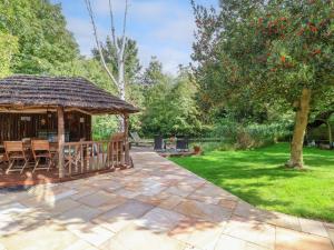 a patio with a gazebo in a garden at Brook Lodge in Ipswich