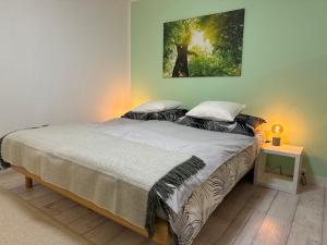 a bedroom with a bed with a painting on the wall at Gabi's Wolfühloase in Balerna
