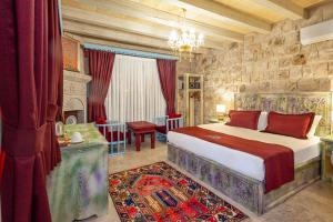 a bedroom with a king sized bed in a room at Han Cave Suites - The Special Class in Göreme
