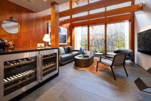 a living room with a large wine cellar at Miya Townhouse by Reflections in Kyoto
