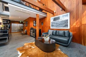 a living room with a couch and a table at Miya Townhouse by Reflections in Kyoto
