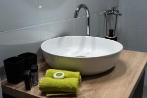 a bathroom with a large white bath tub on a wooden counter at Sani Lux Apartment in Vodno +21 photos