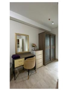 棉兰Podomoro Exclusive Pool View Apartment-5th Floor-Min 2N的一张桌子,带镜子和椅子