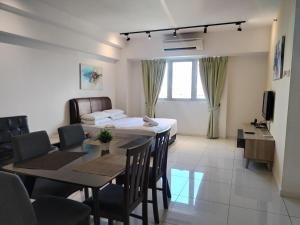 a dining room and living room with a table and chairs at Paragon @ Cyberjaya by Idealhub in Cyberjaya