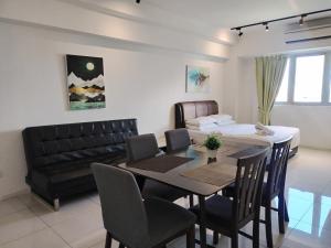 a dining room and living room with a table and chairs at Paragon @ Cyberjaya by Idealhub in Cyberjaya +29 photos