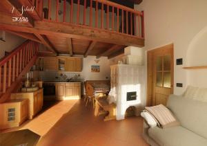 a kitchen with a staircase and a living room at Al Soladif - Mansarda con vista in Cavalese