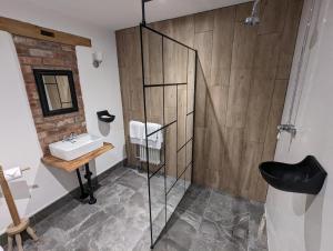 a bathroom with a sink and a glass shower at Abbey Green Farm in Wem