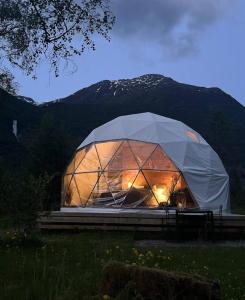 a large glass dome tent with lights in it at Olden Glamping - One with nature in Stryn
