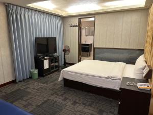 TV a/nebo společenská místnost v ubytování Wecity Hotel 薇城精緻旅店