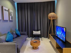 a living room with a couch and a tv at Sky Suites KL City Center in Kuala Lumpur
