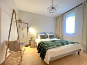 a bedroom with a swinging bed and a window at Cozy Tartu Apple Garden Suite with Sauna in Tartu