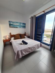 Postel nebo postele na pokoji v ubytování Famara San Borondon + 15 fotografií