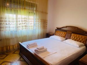 a bedroom with a bed with two towels on it at Berat Feeling Guesthouse in Berat