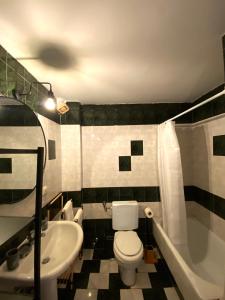 a bathroom with a white toilet and a sink at Vaso Apartment in Neos Marmaras