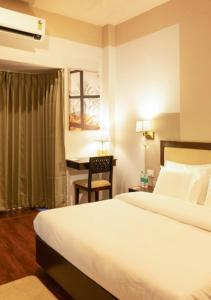 a hotel room with a bed and a desk at Firebrick Boutique Residences - AMETHYST HOUSE in Gurgaon