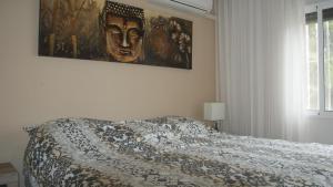 a bedroom with a bed and a painting on the wall at La Casa Hermosa in Algorfa +29 photos