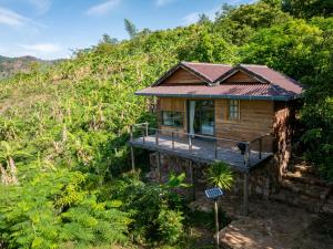 a wooden house in the middle of a hill at Payana Kampot in Kampot