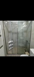 a shower stall in a bathroom with a toilet at Barbara's K House in Káto Garoúna