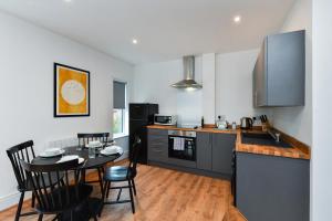 een keuken en eetkamer met een tafel en stoelen bij Charming 2Bed Flat - Spacious & Prime Location in Nottingham