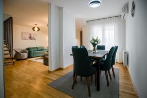 a dining room and living room with a table and chairs at TOP VIEW apartment 43 in Arandelovac