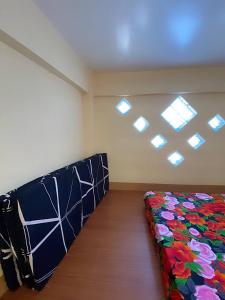 a room with a bed in a room with windows at Loft house @ Patar beach in Bolinao