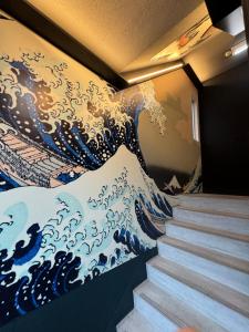 a mural of a wave on a wall at ターミナルホテル東予 in Nyūgawa