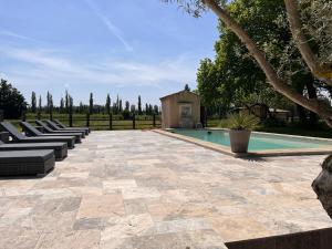 a row of lounge chairs next to a swimming pool at Grand Mas in Tarascon +6 photos