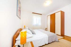 Postel nebo postele na pokoji v ubytování Apartments Cloe