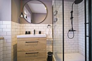 a bathroom with a sink and a shower with a mirror at Apartment Afitojen in Postira