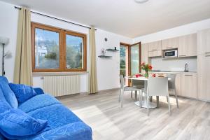 a living room with a blue couch and a table at Casa Milani in Malcesine