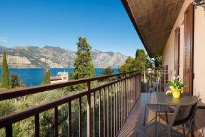 a balcony with a table and a view of the water at Casa Milani in Malcesine