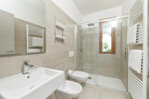 a bathroom with a sink and a toilet and a shower at Casa Milani in Malcesine +40 photos