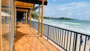 a balcony with a view of the beach at Sameer beachfront Cottages in Canacona