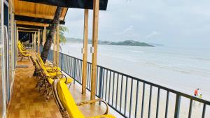 a view of the beach from the balcony of a resort at Sameer beachfront Cottages in Canacona