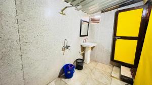 a bathroom with a sink and a mirror and a window at Sameer beachfront Cottages in Canacona