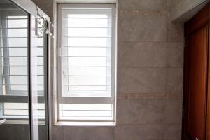 a window in a bathroom with a shower at Family 3bed House in Kampala +18 photos