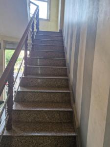 a flight of stairs in a building at Braj Pushp Guest House in Mathura