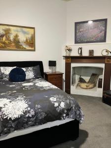a bedroom with a bed and a fireplace at Copper Mine Cottage in Burra