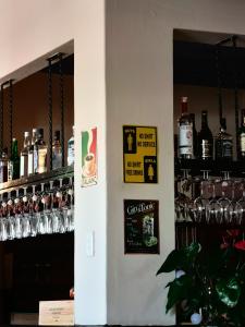 a bar with bottles and glasses on the wall at Capelands Resort, Italian Restaurant & Winery in Cape Town