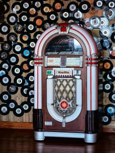 a machine in front of a wall of wine bottles at Capelands Resort, Italian Restaurant & Winery in Cape Town