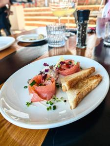 a white plate with food on a table at Capelands Resort, Italian Restaurant & Winery in Cape Town