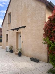 a building with a tire sitting outside of it at La Petite Maison in Montbard