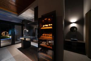 a kitchen with a shelf with bottles of wine at ELSUENITOhinase in Hinase +17 photos